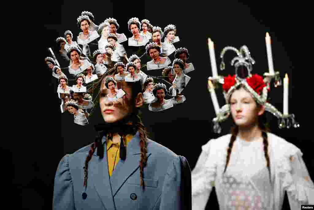 A model presents a creation adorned with images of Britain's Queen Elizabeth II at London Fashion Week Women's A/W19.