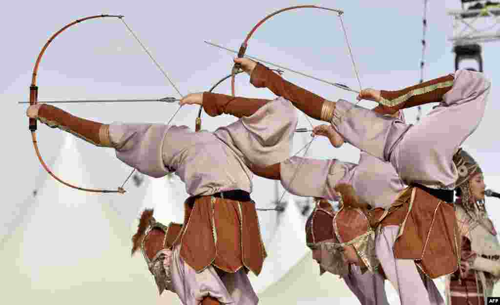 Kyrgyz dancers perform in a gathering of bedouins and nomads from around the world as part of the annual King Abdulaziz Camel Festival in Rumah desert, northeast of the Saudi capital Riyadh.