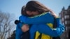 Boston Marathon runners Lisa Kresky-Griffin and Tammy Snyder (L) embrace at the barricaded entrance at Boylston Street near the finish line, April 16, 2013.