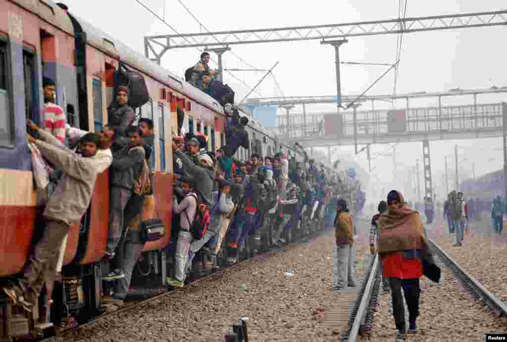 Commuters travel in an overcrowded train near a railway station in Ghaziabad, on the outskirts of New Delhi, India, Feb. 1, 2019.
