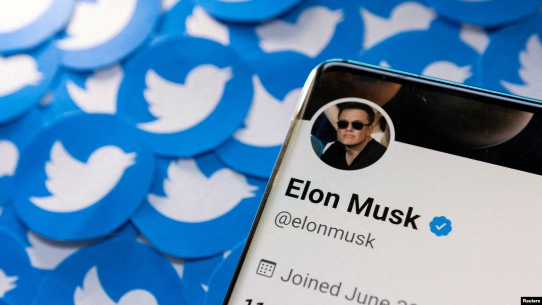 FILE - Elon Musk's Twitter profile is seen on a smartphone placed on printed Twitter logos in this picture illustration taken April 28, 2022.