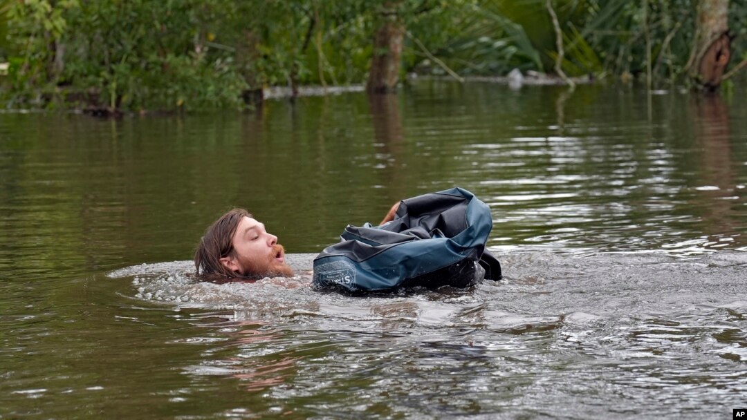 Connor Hughes moves in deep floodwaters left by Hurricane Milton along the Alafia River on Oct. 11, 2024, in Lithia, Florida.