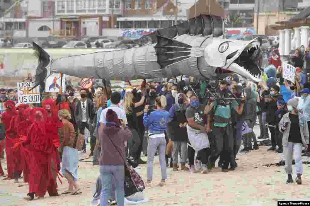 A giant puppet of a Snoek, a type of common local Mackeral, is displayed as hundreds of people take part in a protest against the plan by Dutch oil company, Shell, to conduct underwater seismic surveys along South Africa's East coast, at Muizenberg Beach in Cape Town.