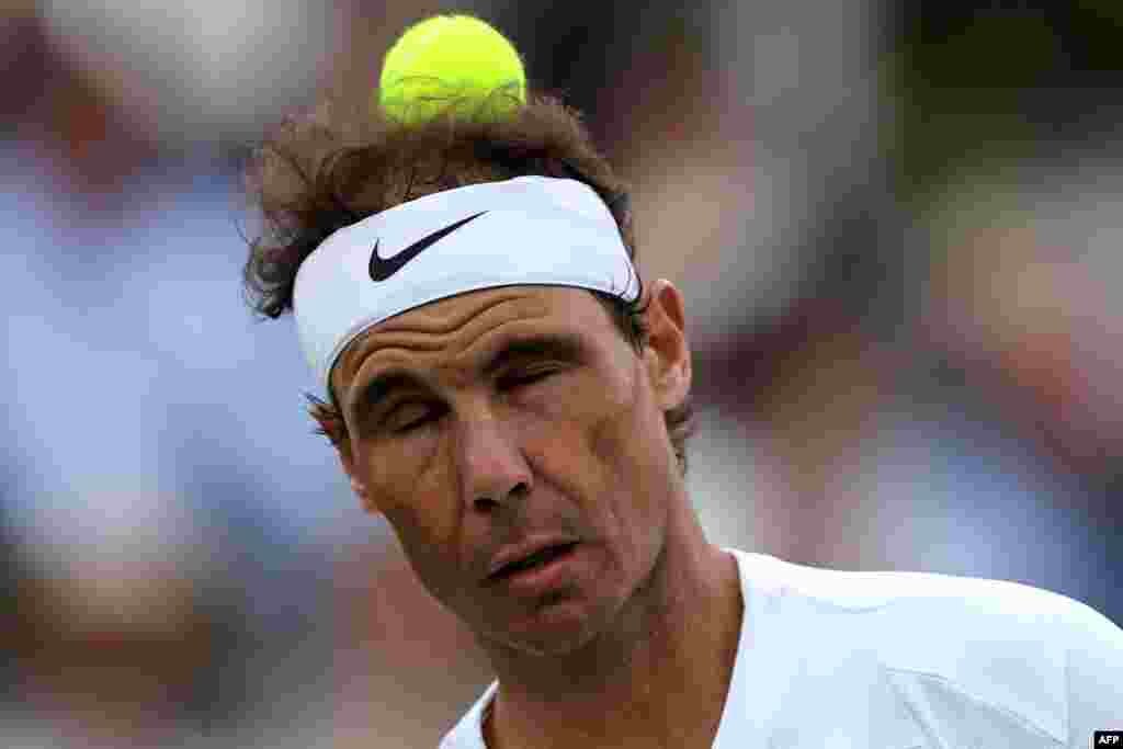 Spain's Rafael Nadal heads the ball as he plays against Canada's Felix Auger-Aliassime during their men's exhibition singles match at The Giorgio Armani Tennis Classic tournament at the Hurlingham Club in London.