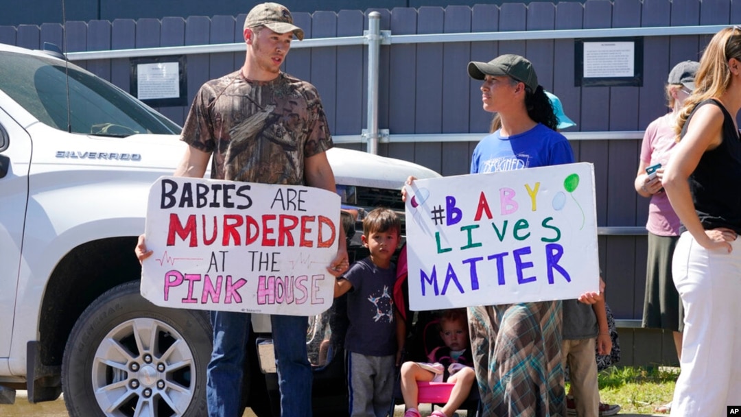 A family of abortion opponents stand outside the Jackson Women's Health Organization clinic in Jackson, June 25, 2022.