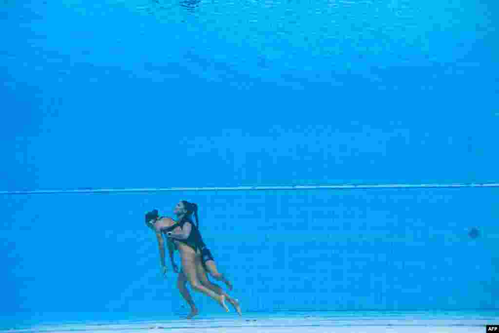 A member of Team USA (R) recovers Anita Alvarez (L), from the bottom of the pool during in the women's solo free artistic swimming finals of the Budapest 2022 World Aquatics Championships at the Alfred Hajos Swimming Complex in Budapest, Hungary.