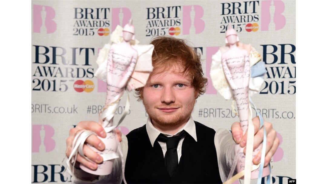 British singer-songwriter Ed Sheeran poses with his British album of the year award for 'X' and his British male solo artist award at the BRIT Awards 2015 in London, Feb. 25, 2015.