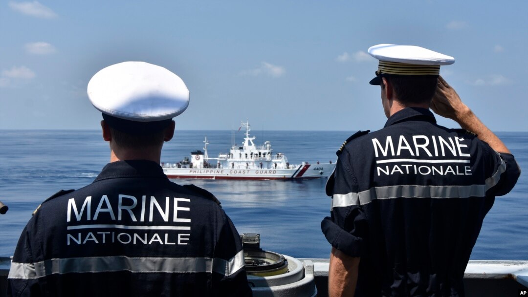 FILE - French navy officers aboard frigate FS Prairial salute at the Philippine coast guard vessel BRP Capones during a passing exercise at the waters of South China Sea on March 20, 2023. (ALPACI - France Pacific Command via AP)