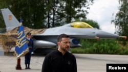 ARCHIVO: El presidente de Ucrania, Zelenskyy, habla con los medios frente a un avión de combate F-16 en el Día de las Fuerzas Aéreas de Ucrania en un lugar no revelado en Ucrania el 4 de agosto de 2024.