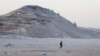 FILE - A Somali government soldier walks on the beach in Eyl, in Somalia's semiautonomous northeastern state of Puntland, March 6, 2017. Somali pirates seized a small boat and kidnapped its Indian crew members, holding them on land for nine days before they were freed by Somali security forces.