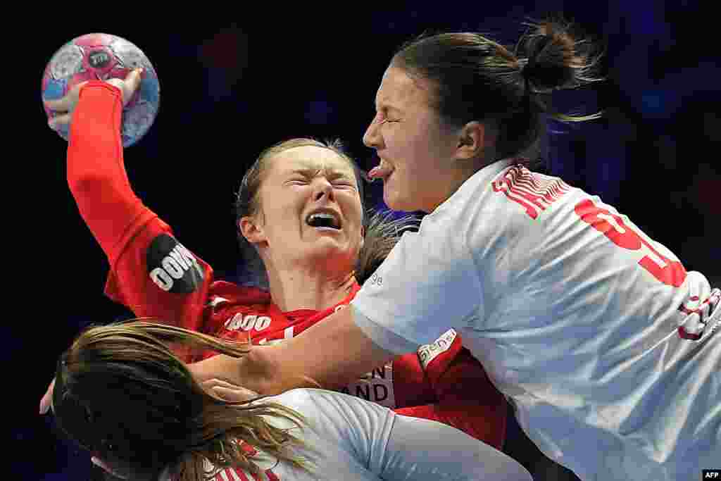 Denmark's left back Anne Mette Hansen (C) vies with Montenegro's left back Durdina Jaukovic during the Euro 2018 European Women's Handball Championship Group 1 main round match between Denmark and Montenegro at the XXL hall in Nantes, western France.