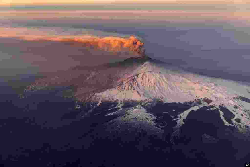 Smoke billows from Mount Etna volcano, the largest of Italy's three active volcanoes, near the Sicilian town of Catania, southern Italy, Feb. 20, 2019.