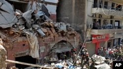 File - French and Lebanese firemen search in the rubble of a building after the explosion of Aug. 4, 2020 at the seaport of Beirut, Lebanon.