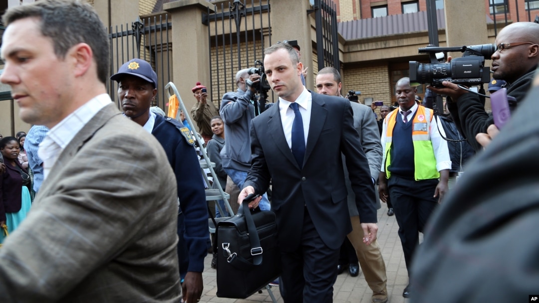 Oscar Pistorius, center, leaves after the court adjourned for the day in Pretoria, South Africa, on May 6, 2014. 