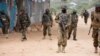 AMISOM soldiers and armored vehicles pass a woman riding a cart during a patrol at a village outside Mogadishu, Sept. 19, 2016. (Photo: J. Patinkin/VOA)