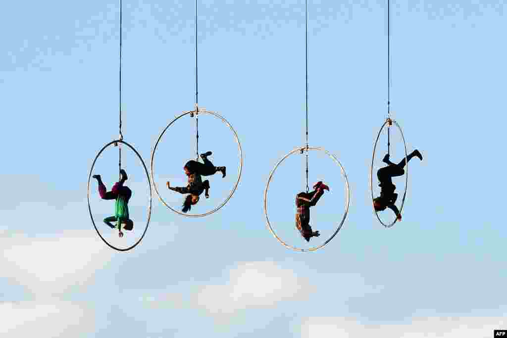 Aerial dancers of the Kitonb theater group, hanging from a crane, perform during rehearsals ahead of their New Year's show at the Circus Maximus in Rome, Italy.