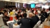 FILE - Local businessmen and foreign investors negotiate at a cross-border investment and trade fair in Guiyang, Guizhou province, China, Nov. 10, 2016. 