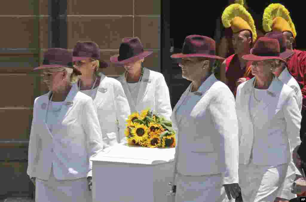 Pallbearers carry the coffin of Tori Johnson during the funeral service in Sydney, Australia, Dec. 23, 2014.