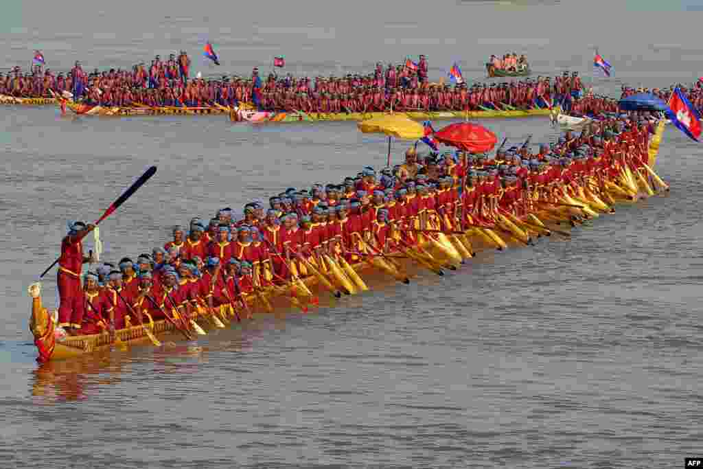 The world's longest dragon boat carrying 179 rowers sail along the Mekong river during a ceremony in Prey Veng province, Cambodia.