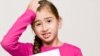 A student holds a test with the failing letter grade of "F."