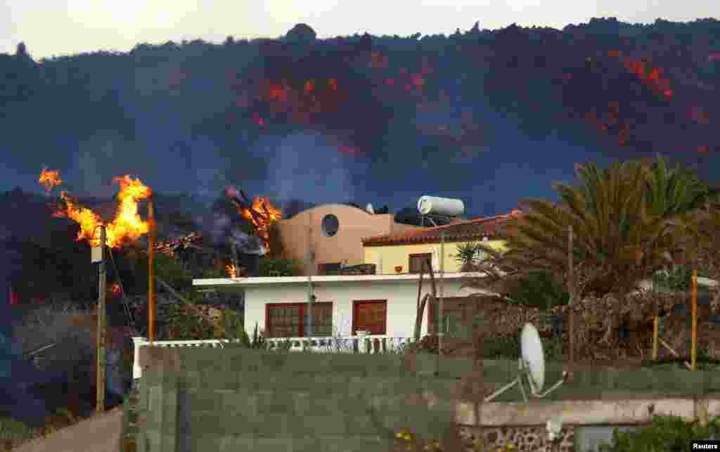 A house burns following the eruption of Cumbre Vieja Volcano, on the Canary Island of La Palma, Spain, Oct. 27, 2021.