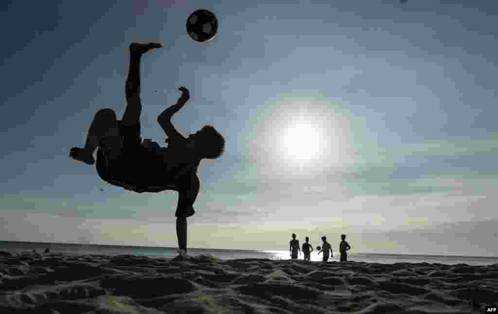A boy plays soccer along a beach on the Philippine island of Boracay.