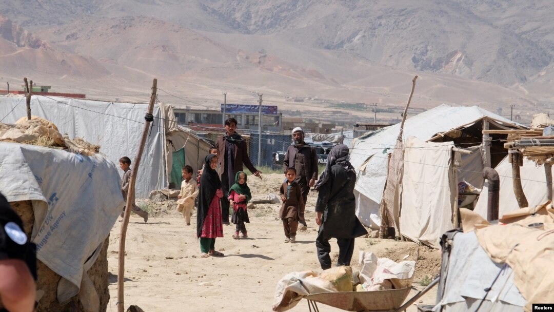 FILE - Internally displaced Afghans at a camp outside Kabul, Afghanistan, during a visit by United Nations Secretary-General Antonio Guterres June 14, 2017. UN refugee agency estimates eight million Afghans do not live in their homes, fleeing deadly conflict, poverty, unemployment and a worsening drought in Afghanistan.