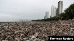 Plastic waste pile and debris are seen up near the beach in Panama City
