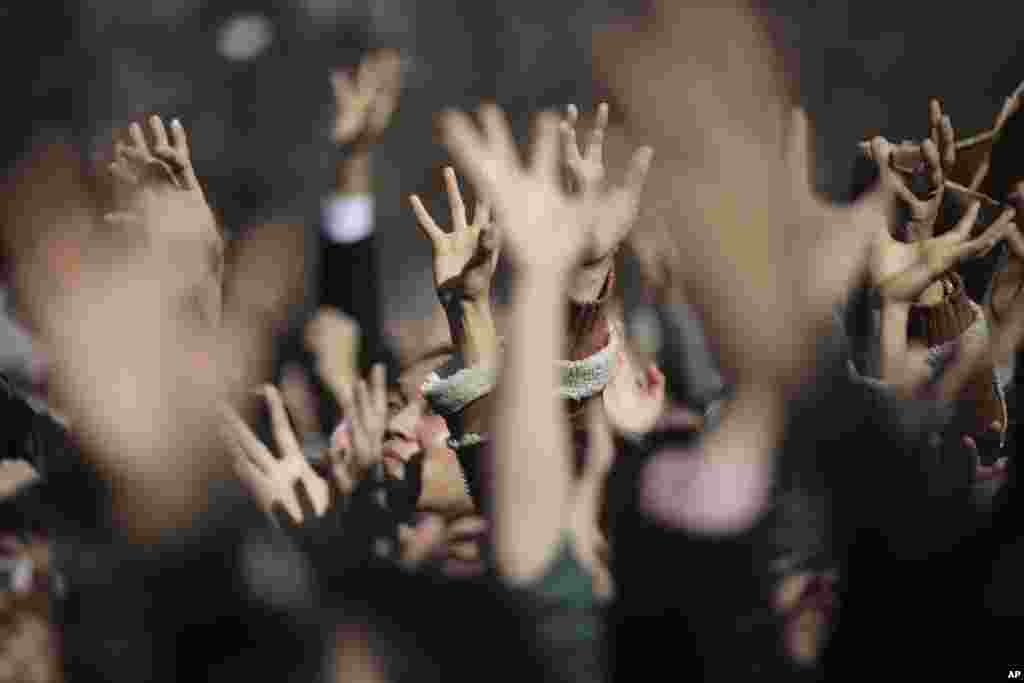People try to catch lucky beans scattered by celebrities during "Mame-maki," a bean throwing ceremony, at Zojyoji Buddhist temple in Tokyo, Japan.