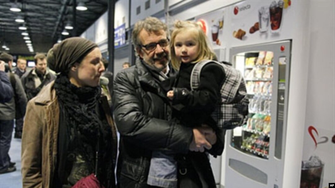 Passengers arrive after being evacuated from Tripoli in crisis-hit Libya at Roissy Charles-de-Gaulle airport, north of Paris France, February 23, 2011