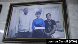 A picture hanging in Ko Ni's family home shows him and his wife (right) posing with Aung San Suu Kyi.