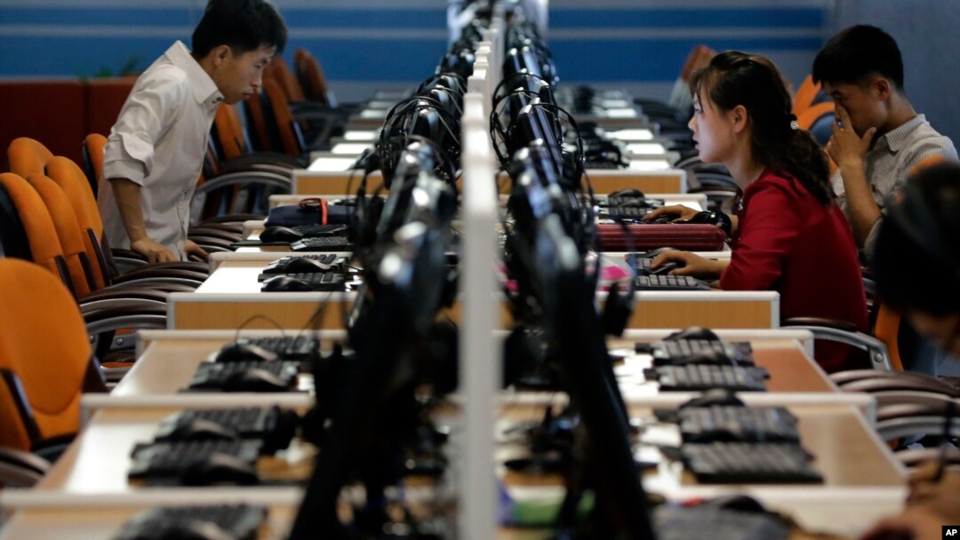 FILE - North Korean men and women use computer terminals at the Sci-Tech Complex in Pyongyang, N. Korea, June 16, 2017. On Feb. 16, 2021, S. Korea's intelligence service said N. Korean hackers attempted to steal information about coronavirus vaccines.