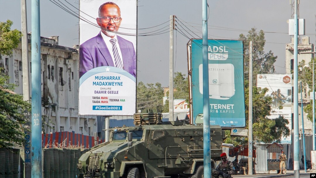 FILE - Security forces block a street with an armored personnel carrier during protests against the government and the delay of the country's election in the capital, Mogadishu, Somalia, Feb. 19, 2021.