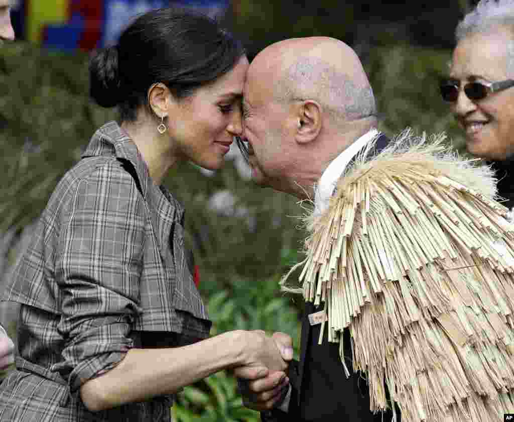 Meghan, Duchess of Sussex receives a "hongi" a traditional Maori welcome on the lawns of Government House in Wellington, New Zealand.