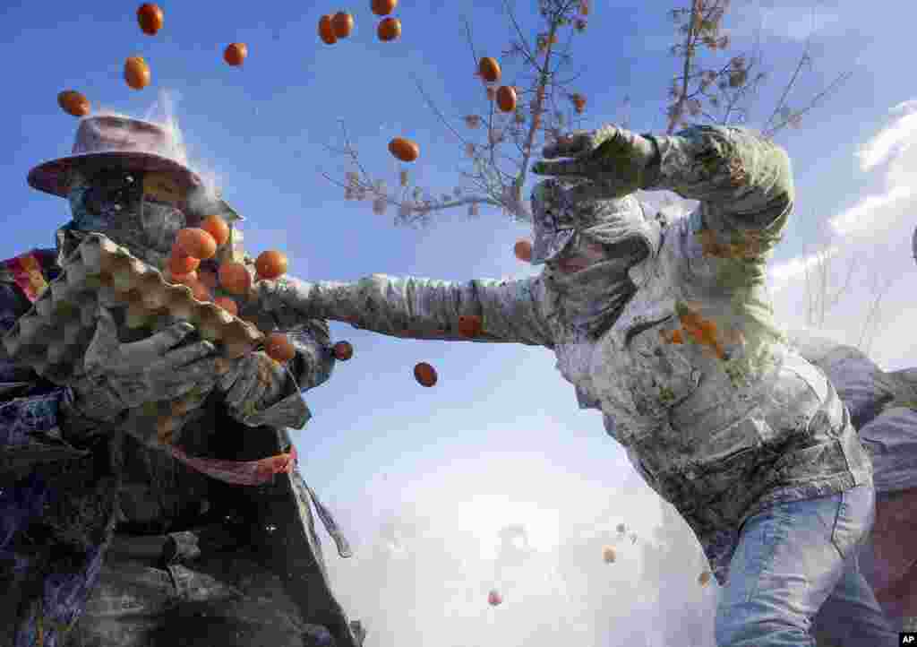Revelers take part in the Els Enfarinats festival, in the town of Ibi near Alicante, Spain. For about 200 years, the inhabitants of Ibi annually celebrate with a battle using flour, eggs and firecrackers, outside the city town hall.
