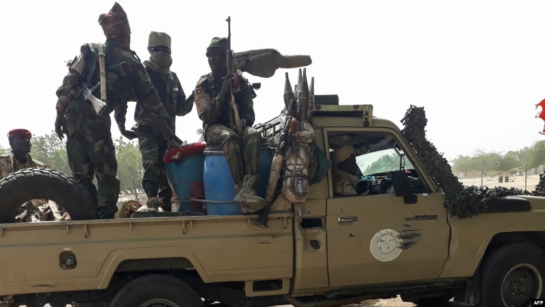 FILE - Soldiers of the Chad Army sit on the back of a Land Cruiser at the Koundoul market, 25 km from N'Djamena, Jan. 3, 2020, upon their return from a mission fighting Boko Haram.