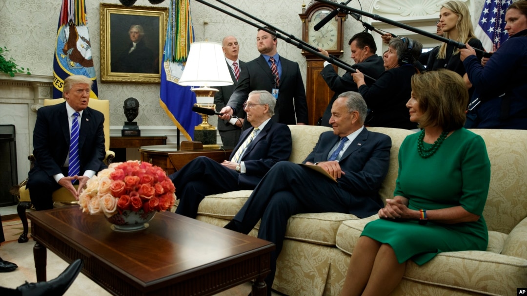 President Donald Trump speaks to, from left, Senate Majority Leader Mitch McConnell, R-Ky., Senate Minority Leader Chuck Schumer, D-N.Y., and House Minority Leader Nancy Pelosi, D-Calif., during a meeting with Congressional leaders in the Oval Office of the White House, Sept. 6, 2017, in Washington. 