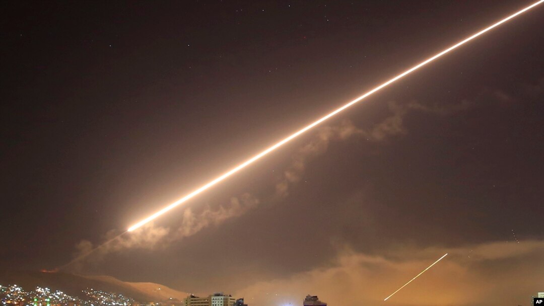 Damascus skies erupt with surface to air missile fire as the U.S. launches an attack on Syria targeting different parts of the Syrian capital Damascus, Syria, early Saturday, April 14, 2018.