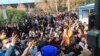 FILE - In this Saturday, Dec. 30, 2017 file photo taken by an individual not employed by the Associated Press and obtained by the AP outside Iran, university students attend a protest inside Tehran University while anti-riot Iranian police prevent them to
