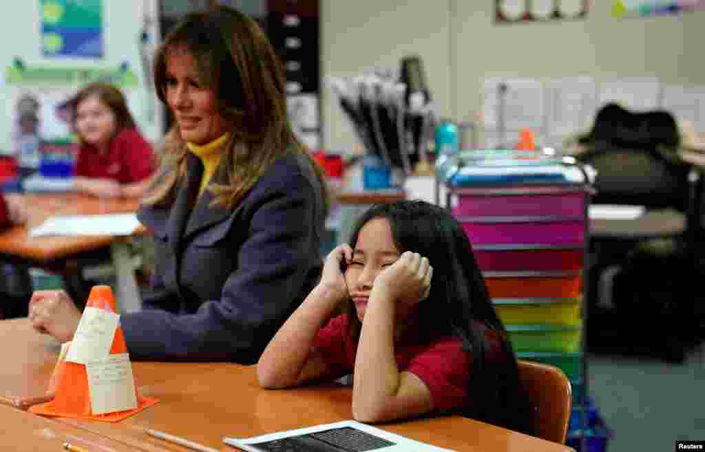 A student sits with her head in her hands as U.S. first lady Melania Trump visits the Dove School of Discovery during a two-day, three-state tour promoting her "Be Best" initiative in Tulsa, Oklahoma, March 4, 2019.