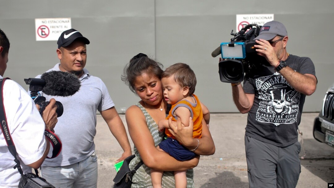File- Adalicia Montecino and her husband Rolando Bueso Castillo walk with their year-old son Johan Bueso Montecinos, who became a poster child for the U.S. policy of separating immigrants and their children, in San Pedro, Feb. 4, 2017.