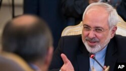 Iranian Foreign Minister Mohammad Javad Zarif, right, speaks to Russian Foreign Minister Sergey Lavrov, back to a camera, during their meeting in Moscow, Aug. 29, 2014. 