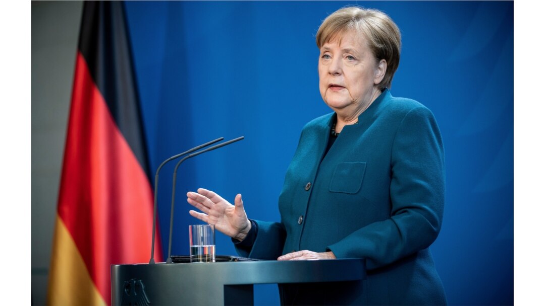 FILE - German Chancellor Angela Merkel speaks at a press conference about coronavirus, in Berlin, March 22, 2020.