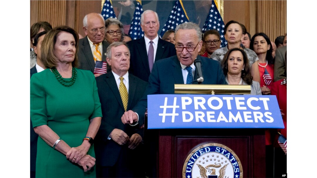 Senate Minority Leader Chuck Schumer of N.Y., accompanied by House Minority Leader Nancy Pelosi of Calif., left, and others members of the House and Senate Democrats, speaks during a news conference on Capitol Hill in Washington, Wednesday, Sept. 6, 2017.