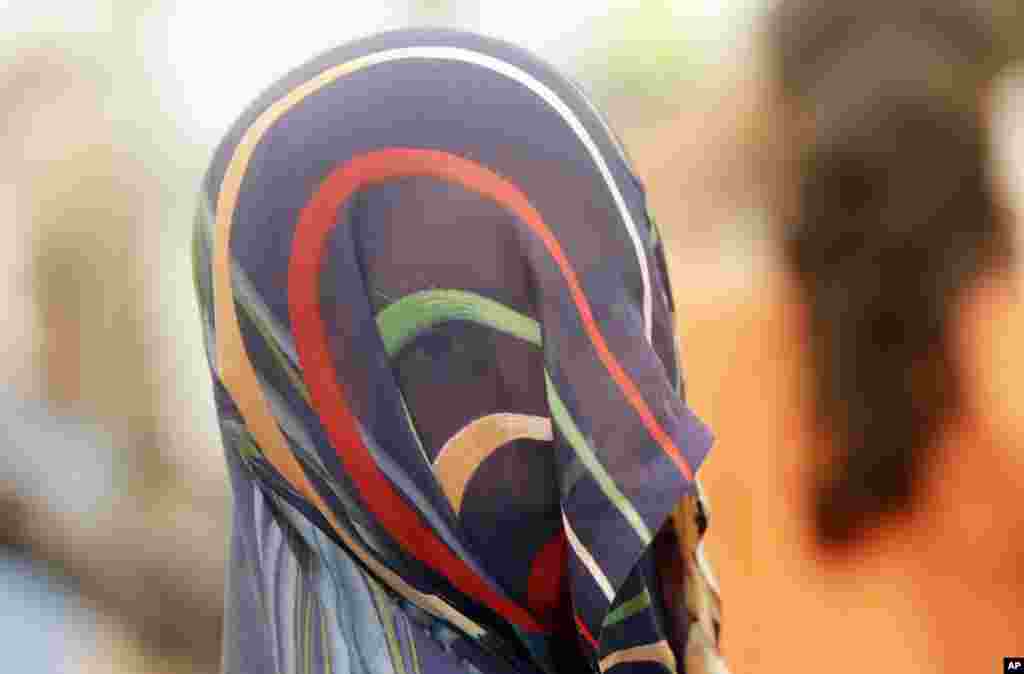A victim of sexual violence participates in a Dignity March in Mumbai, India.
