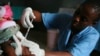 FILE - A child is vaccinated during a malaria vaccine trial in Bagamoyo, Tanzania, Aug. 2007.