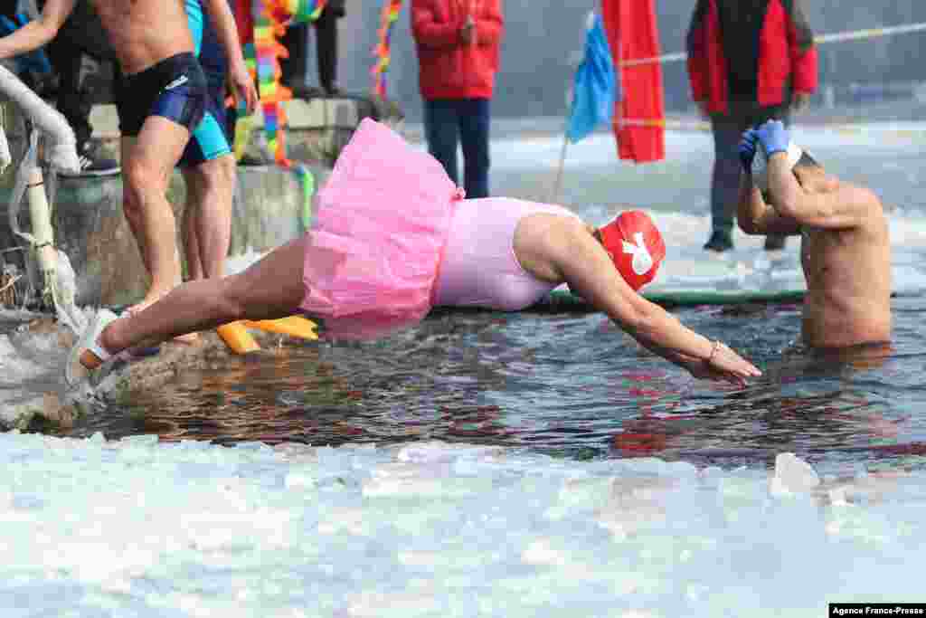 A winter swimming enthusiast dives into a partly frozen lake in Shenyang, in northeastern China's Liaoning province.