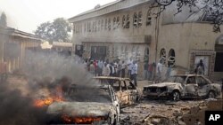 A car burns at the scene of a bomb explosion at St. Theresa Catholic Church at Madalla, Suleja, just outside Nigeria's capital Abuja. Five bombs exploded on Christmas Day at churches in Nigeria, one killing at least 27 people, raising fears that Islamist