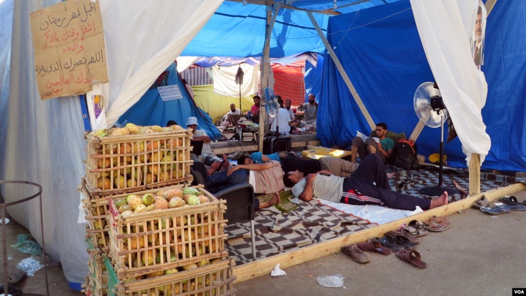 Some people are operating businesses like prickly-pears for sale in crates, but pro-Morsi protesters say most of the people living in this tent village spend the hot days resting, reading Koran, and preparing for rallies. (Heather Murdock for VOA)