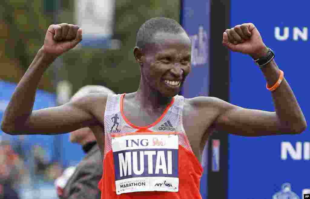 Geoffrey Mutai of Kenya celebrates his first place win in the men's division of the New York City Marathon, Nov. 3, 2013.